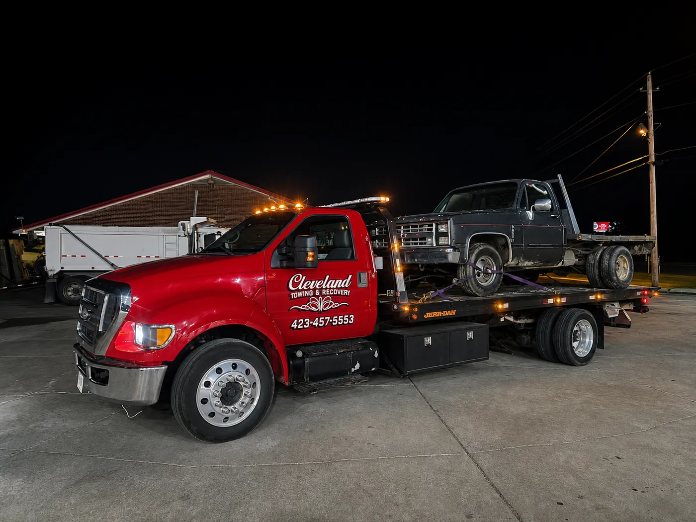 An older non-running pickup winched up onto our rollback deck at night
